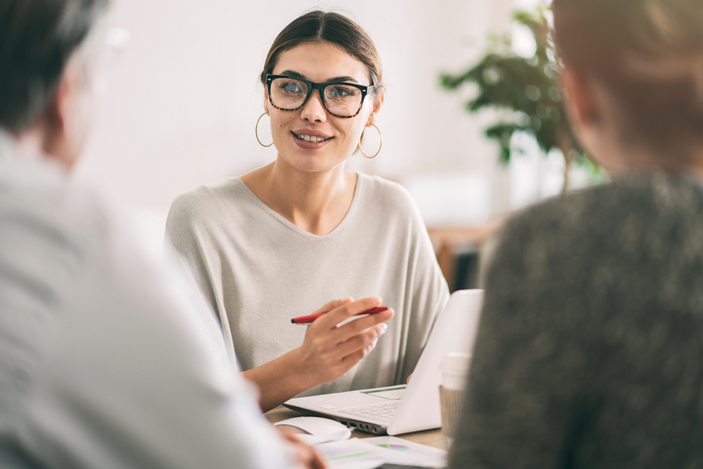 Businesswoman discussing on senior couple