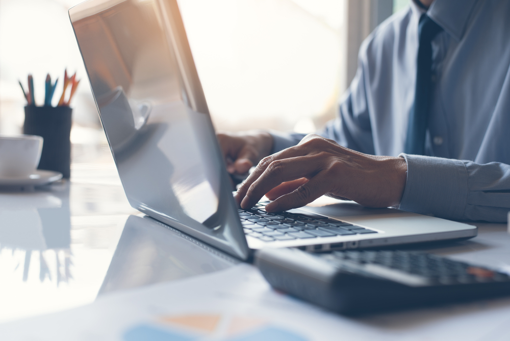 businessman typing on his laptop